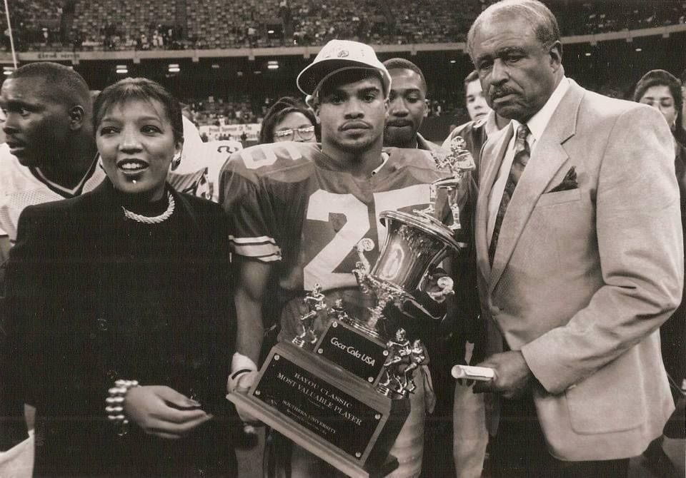 Coach Sean Wallace in his Southern University number 25 jersey, holding the Bayou Classic Most Valuable Player trophy.
